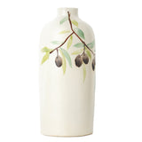 White ceramic olive oil decanter with a painted green branch and black olives on a white background.